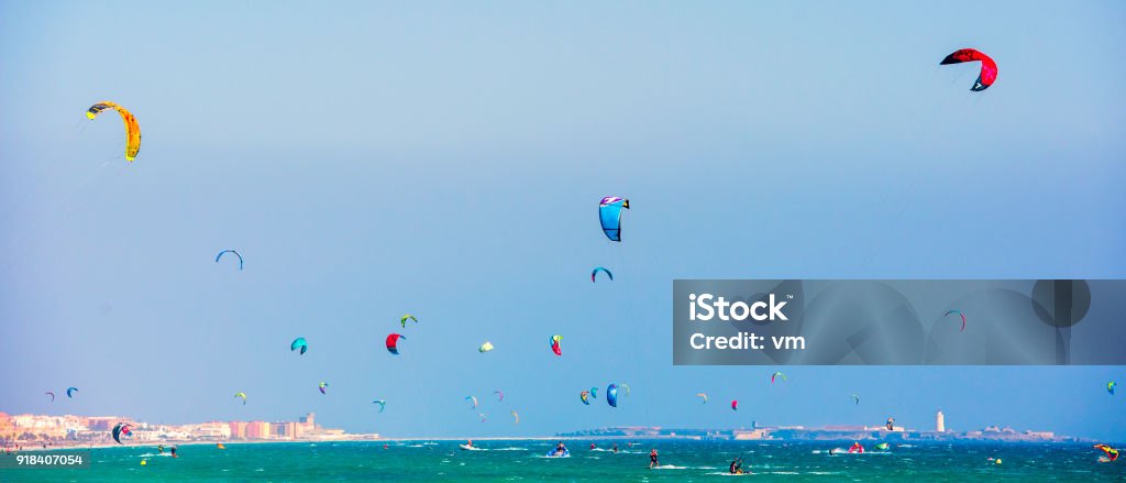 Large group of kitesurfers at sea Panoramic photo of a large group of kiteboarders on the sea near a city beach. Active Lifestyle Stock Photo