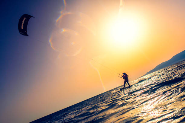 istock Silhouette of a kiteboarder against the sun 918407272