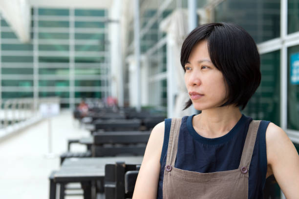 istock Young Asian lady at outdoor cafe 918409682