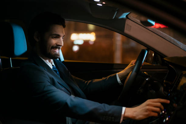 istock Businessman in car at night 918410868