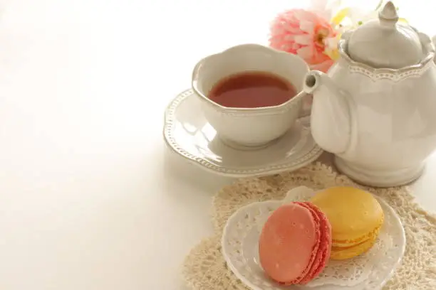 Photo of Pastel color confection, french food Macaron and tea