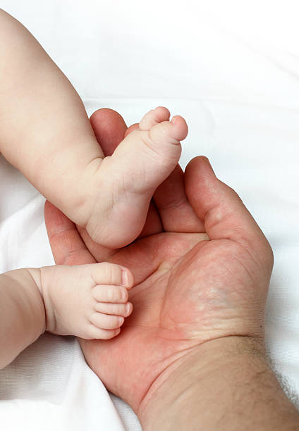 istock baby foots on father palm 91841442