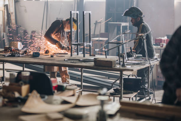 istock Steel workers working on a metal in a workshop. 918418452