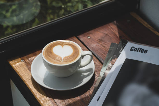 istock hot coffee with heart latte art shape on wood table 918418702