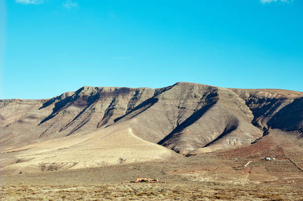Volcanic hills and blue sky in Lanzarote Island, Canaries, Spain
