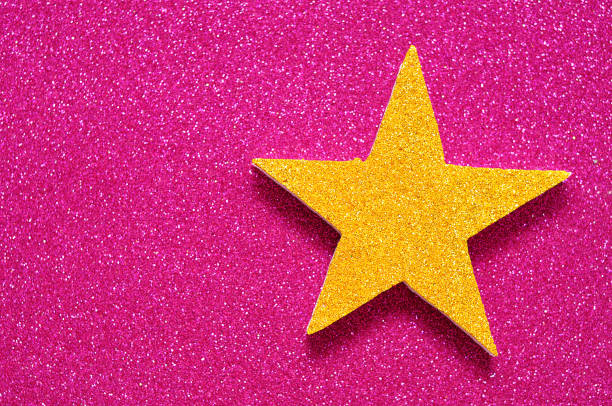 istock A golden star on a shinny pink background 918422584