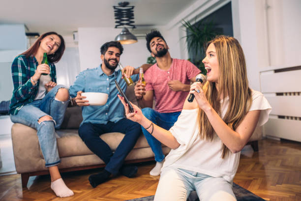 istock Group of friends playing karaoke at home 918423570