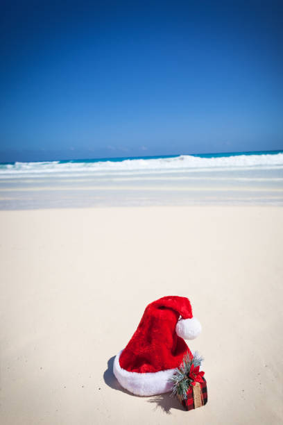 istock Santa Hat and gifts on beach 918426954
