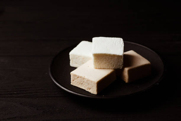istock marshmallow in a black plate on black wood table 918427290