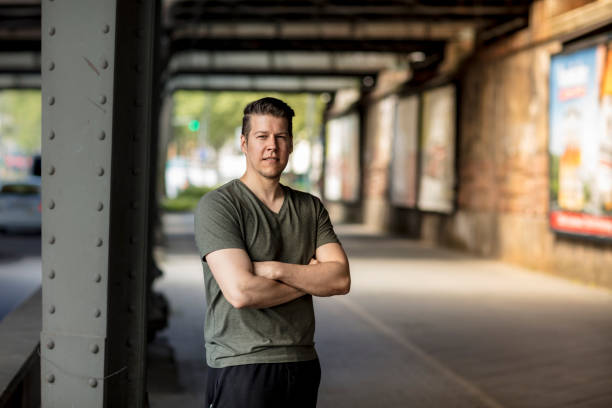 istock Sporty Man Standing Under a City Bridge 918427714