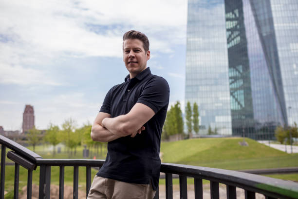istock Man Leaning on Outdoor Balustrade, and Skyscraper 918427884