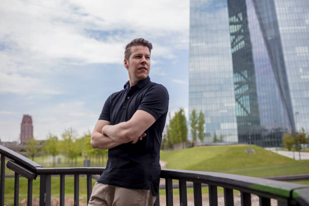 istock Man Leaning on Outdoor Balustrade, and Skyscraper 918427918