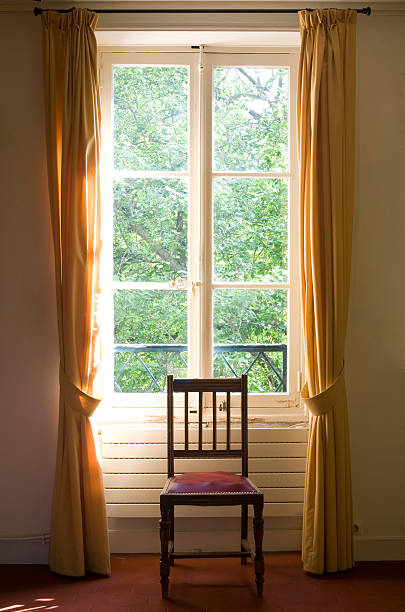 istock Lonely chair in front of tall window 91842813