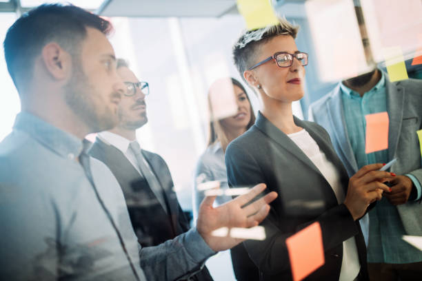 istock Business people planning strategy in office together 918430814