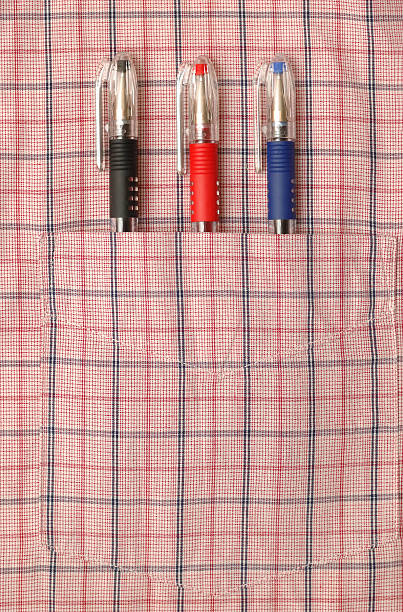 Three pens in shirt pocket stock photo
