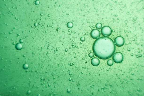 istock Green oil bubbles on water 918433912
