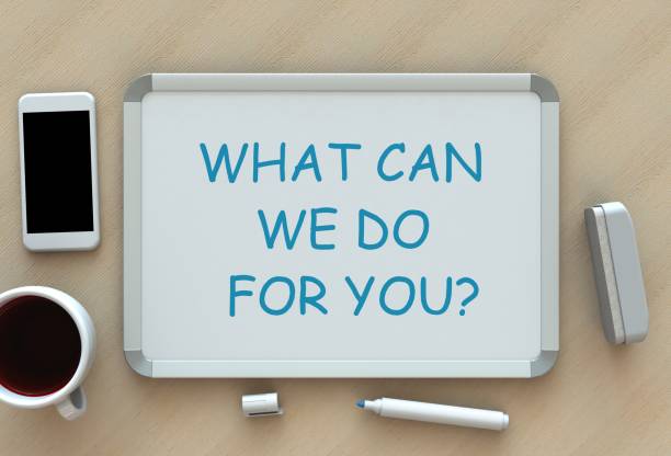 istock WHAT CAN WE DO FOR YOU?, message on whiteboard, smart phone and coffee on table 918434068
