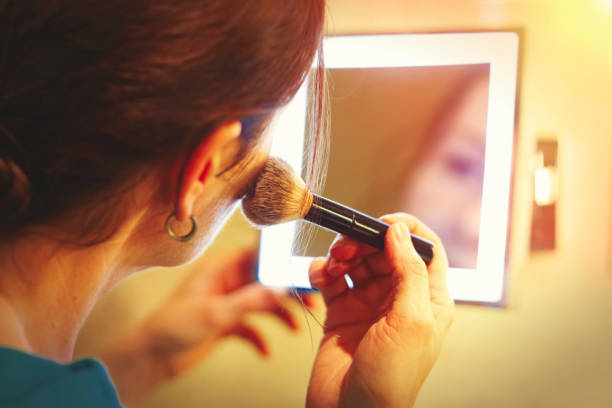istock Mid age woman doing make up with a brush 918436840