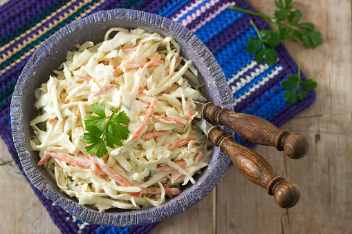 Coleslaw Salad from cabbage and carrots with dressing mayonnaise. Selective focus.
