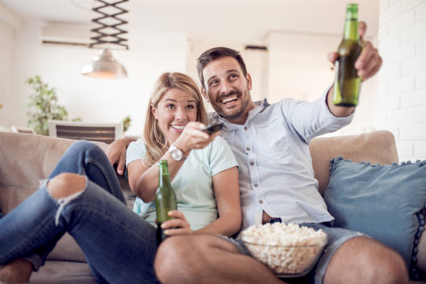 istock Couple watching movie at home 918440784