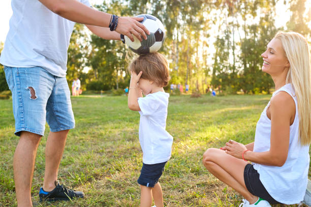 istock Family playing with a ball in the park 918443284