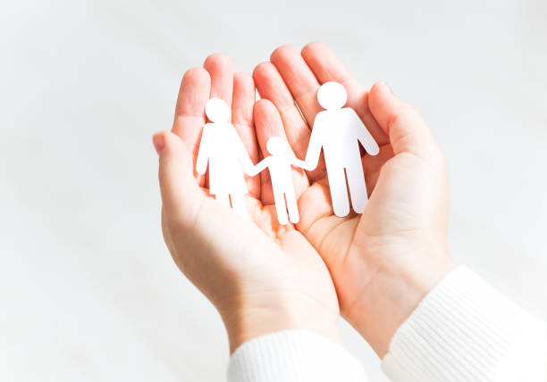 istock Paper cut family in two hands 918443316