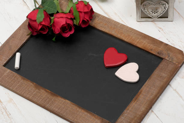 istock concept romantic, small chalkboard, three roses and heart 918444166