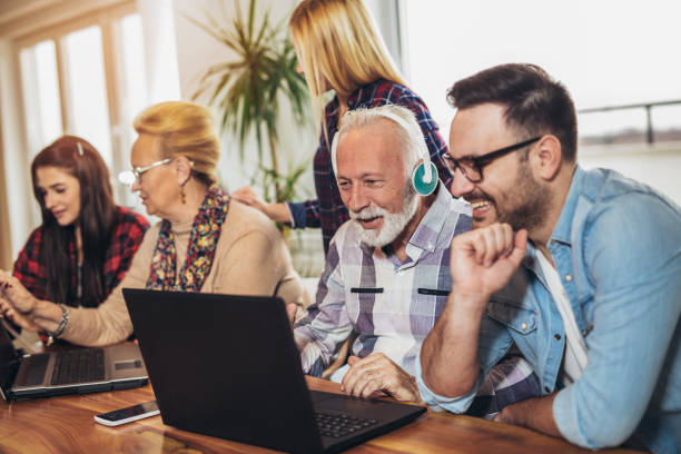 istock Young volunteers help senior people on the computer 918444924