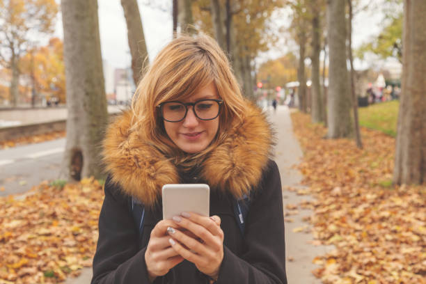 istock Cute girl using cellphone on the street. 918446754