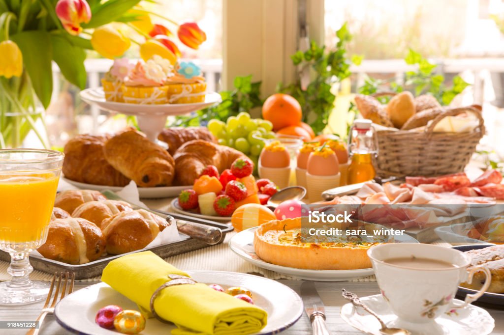 Table with delicatessen ready for Easter brunch Breakfast or brunch table filled with all sorts of delicious delicatessen ready for an Easter meal. Easter Stock Photo