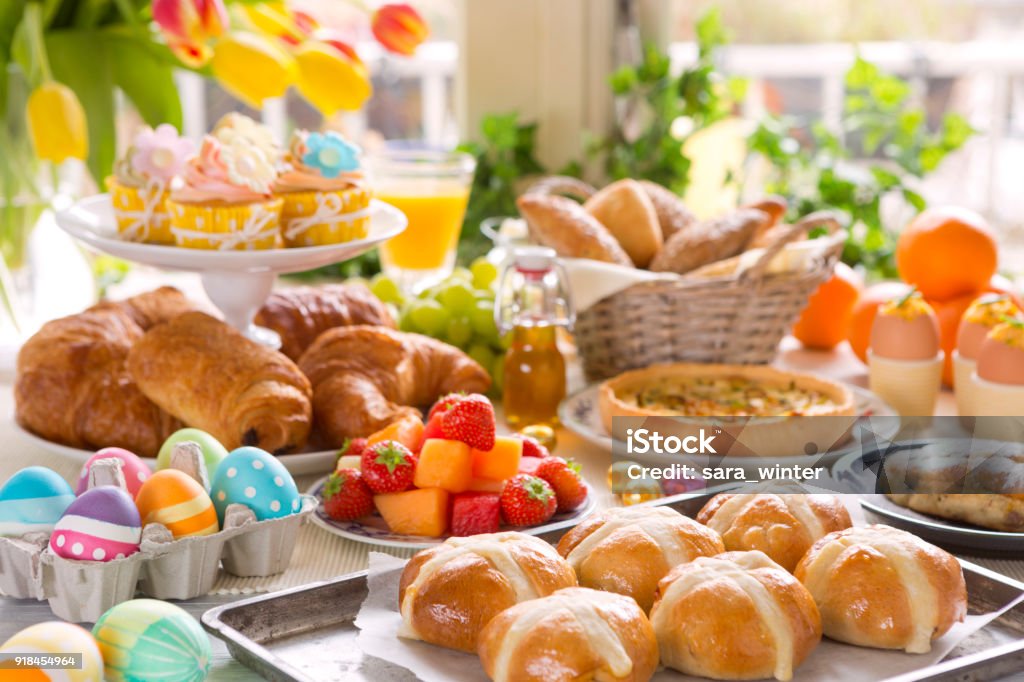 Table with delicatessen ready for Easter brunch Breakfast or brunch table filled with all sorts of delicious delicatessen ready for an Easter meal. Easter Stock Photo