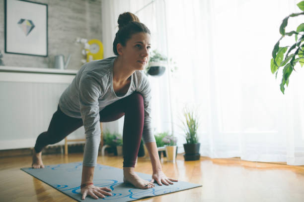 домашняя йога - relaxation exercise stretching exercising women стоковые фото и изображения