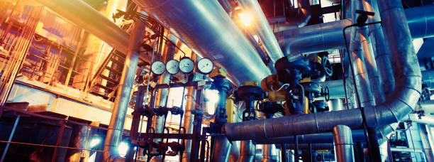 Equipment, cables and piping as found inside of a modern industrial power plant stock photo