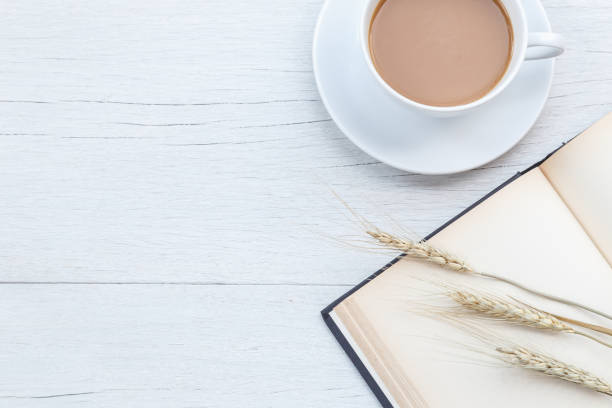 istock Top view coffee and empty book on white wooden table 918458696