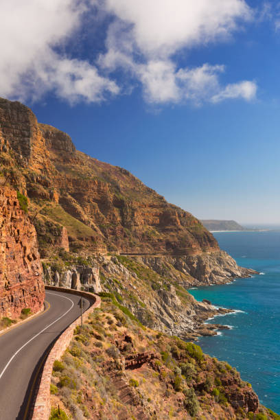 Chapman's Peak Drive near Cape Town in South Africa The Chapman's Peak Drive on the Cape Peninsula near Cape Town in South Africa on a bright and sunny afternoon. chapmans peak drive stock pictures, royalty-free photos & images