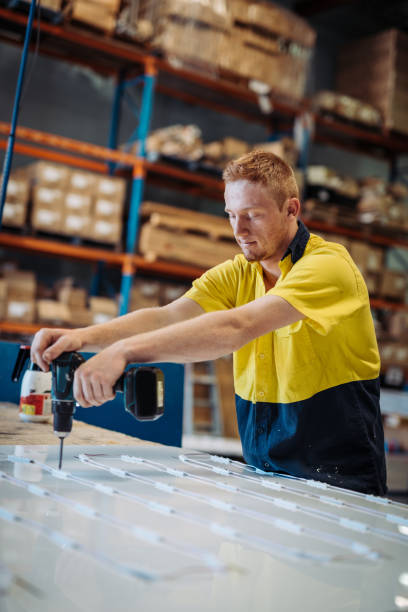 istock Ginger employee working with drill in factory 918458906