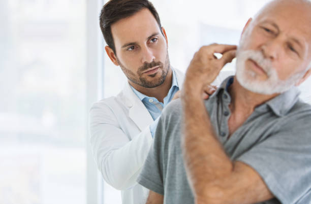 istock Senior man having his neck examined. 918459332