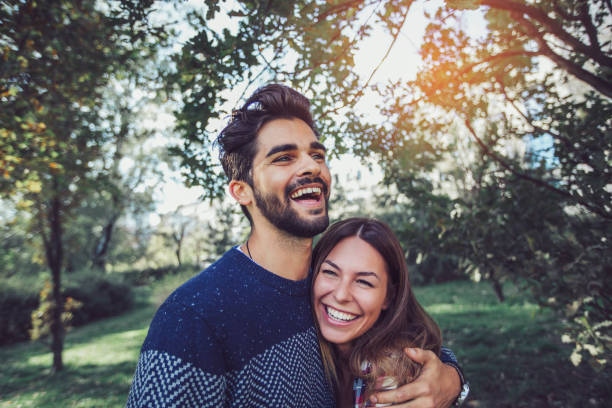 istock Young couple in love having fun at park 918470496