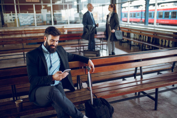 istock Businessman using mobile phone at train station 918470732