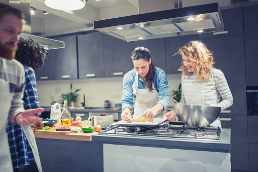 Members of the family being involved in the pizza making process