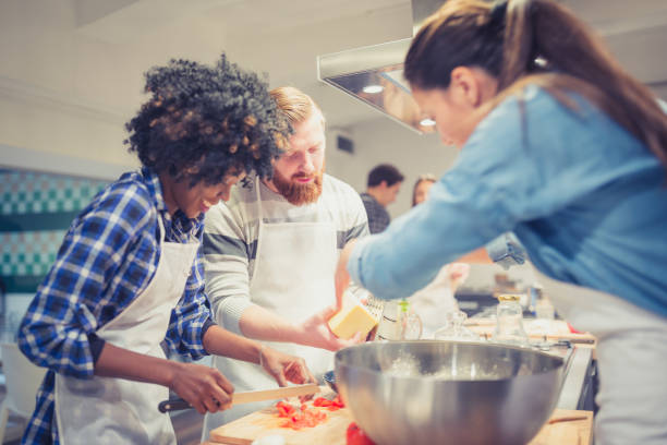 istock Participants of a cooking class working together and having fun 918473408