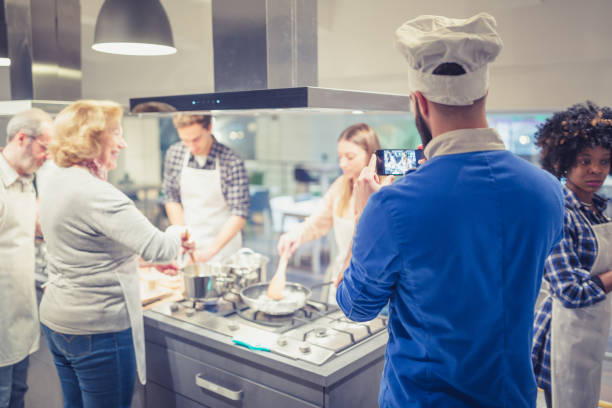 istock Participants of a cooking class working together and having fun 918473468