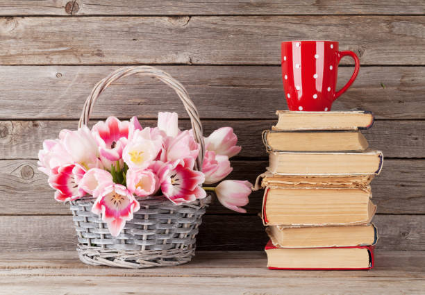 istock Pink tulips bouquet, books and coffee cup 918474690