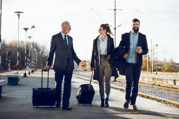 istock Business people with luggage at train station 918474804