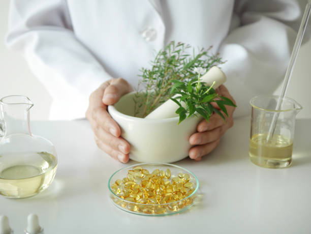 istock scientist or doctor making herbal medicine with herb leaves , capsule, tablets.hands. 918477444