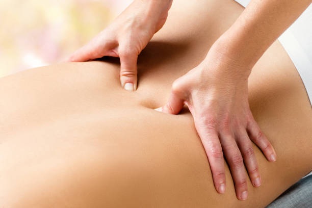 istock Therapist doing lower lumbar massage on woman. 918477802