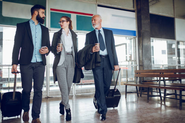 istock Business people with luggage at train station 918477996