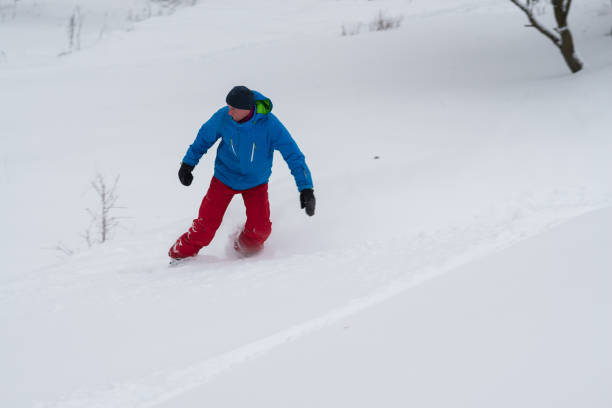 istock Snowboarder rides, in a deep snow 918480684