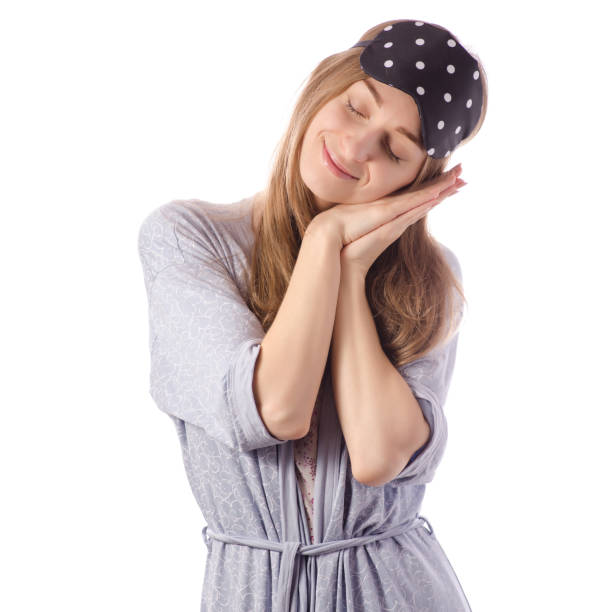 istock Young beautiful woman in a bathrobe with a sleeping mask 918484400