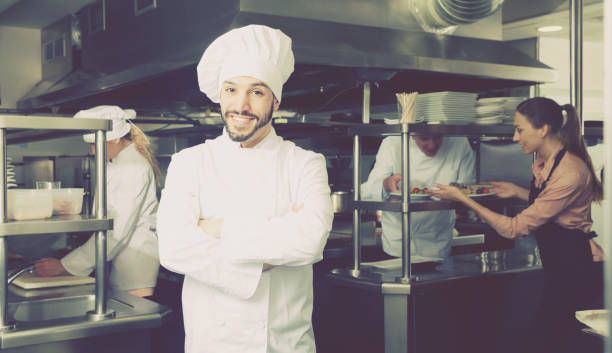 istock Positive chef of restaurant posing in kitchen 918488790